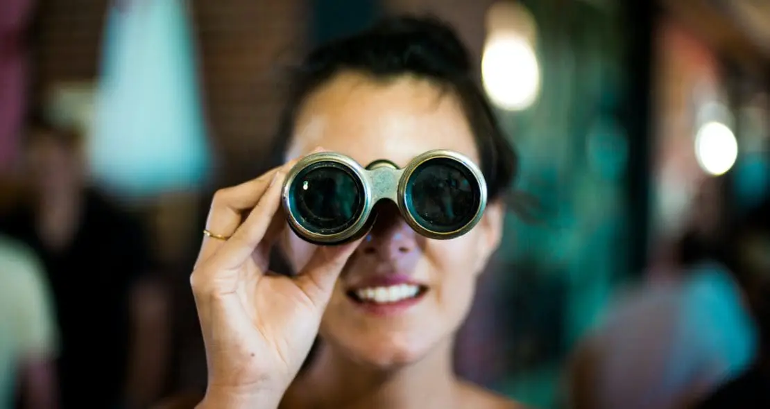 Person looking through binoculars